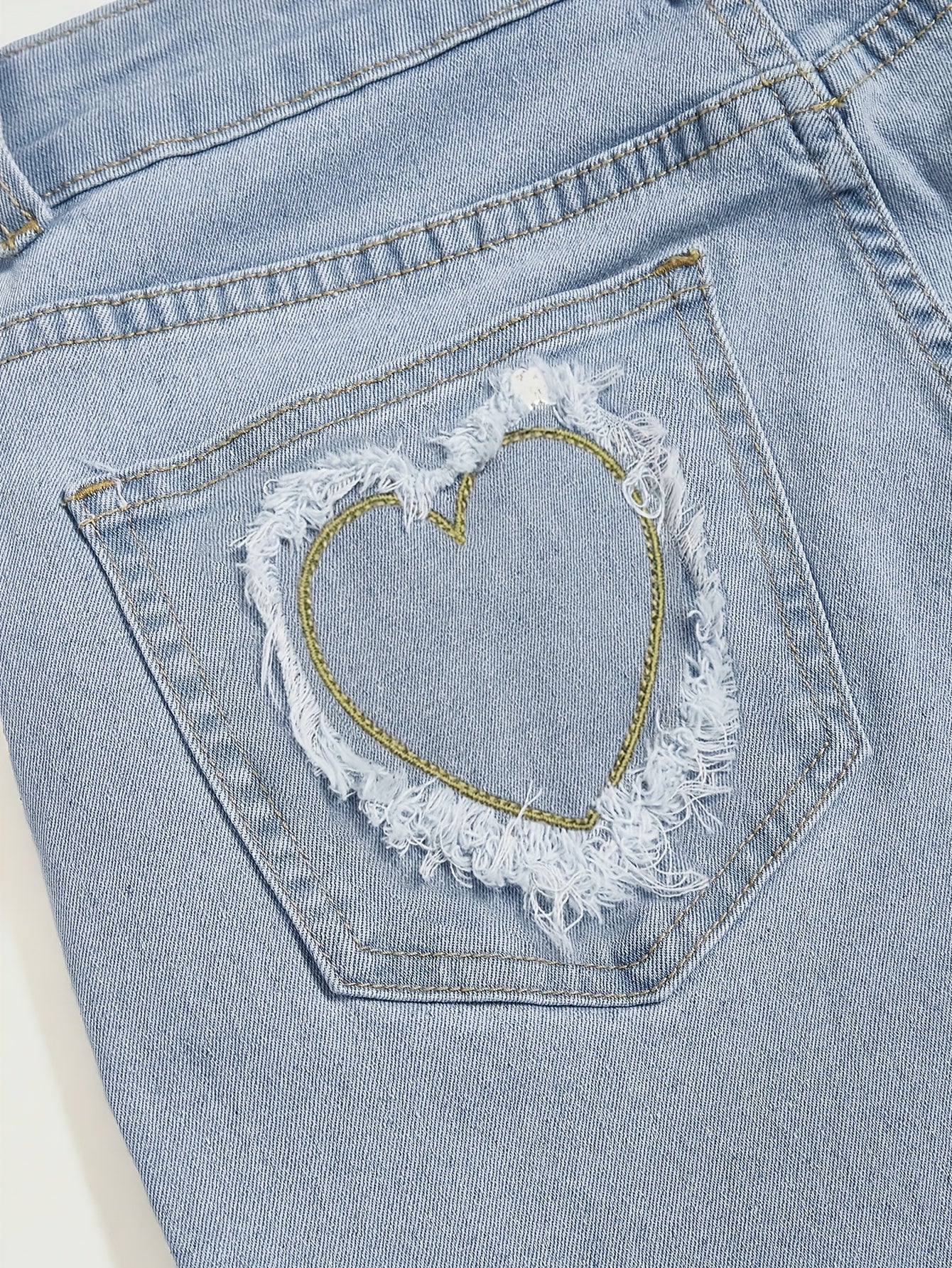 Elegant Light Blue Denim Flare Jeans for Women with Heart Buckle Frayed Belt Western Style