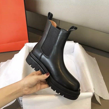 Sleek Black Leather Chelsea Boots for Women with Round Toe Pull Tab Lug Sole Platform Style