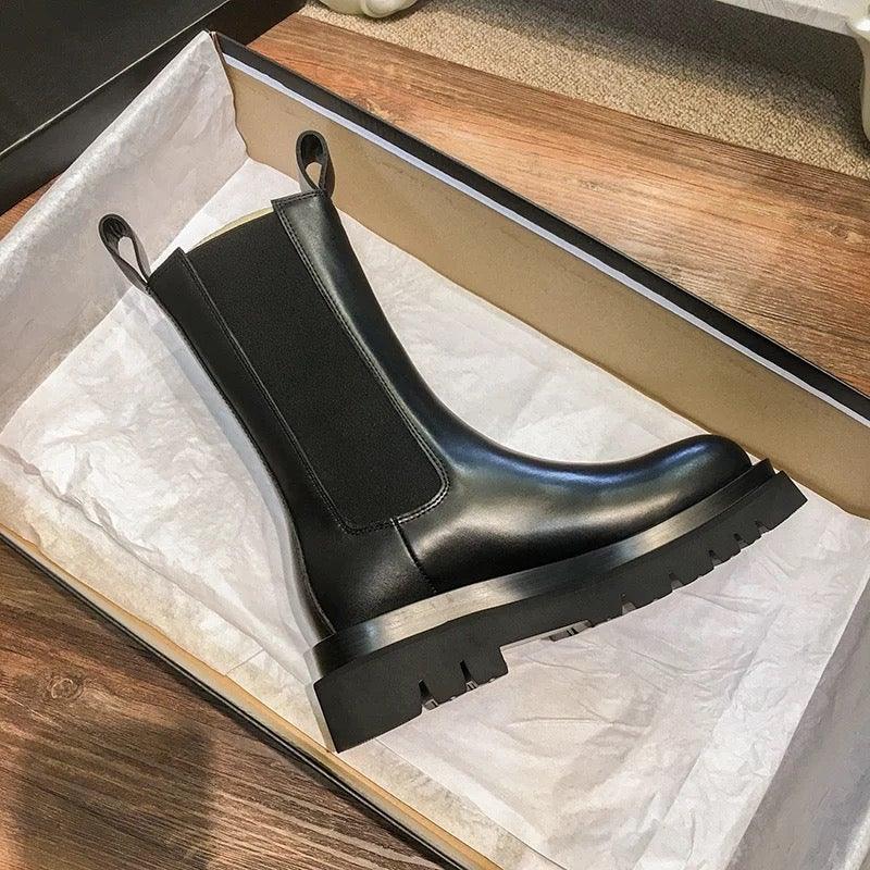 Sleek Black Leather Chelsea Boots for Women with Round Toe Pull Tab Lug Sole Platform Style