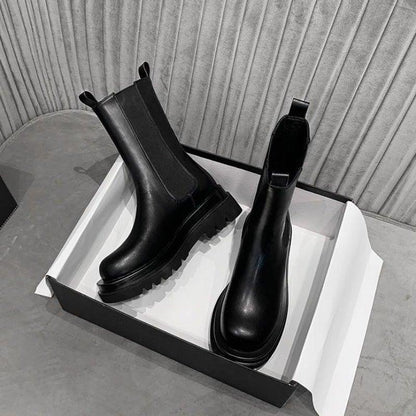 Sleek Black Leather Chelsea Boots for Women with Round Toe Pull Tab Lug Sole Platform Style